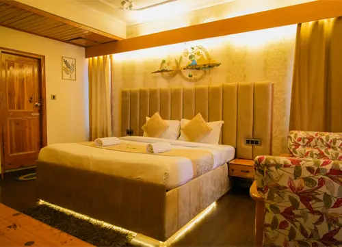 Loop Inn Manali luxury hotel room with king-size bed, ambient lighting, and modern decor